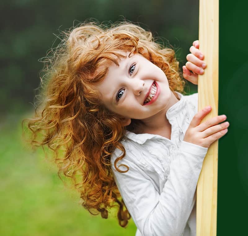 little girl's curly hair with bangs