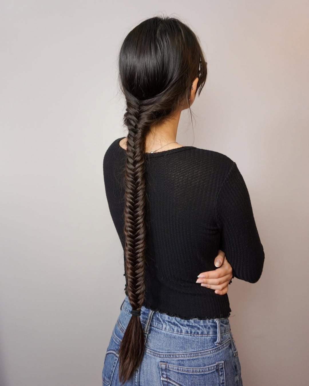 extra long tight fishtail braid on dark brunette hair with twisted side strands