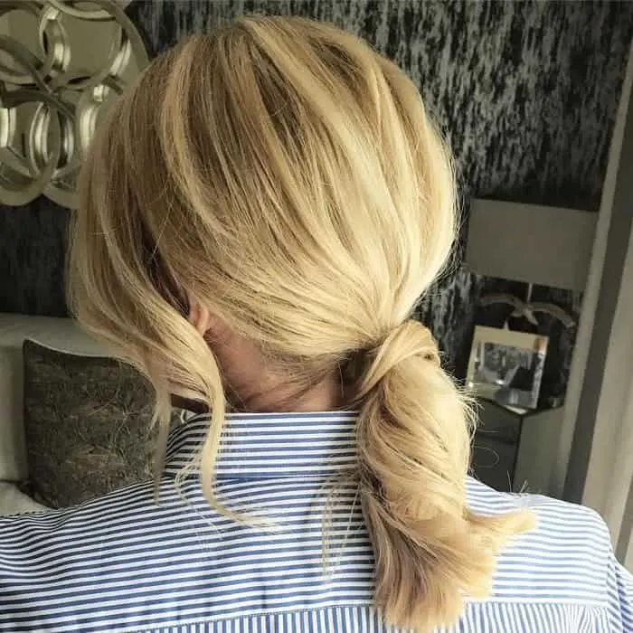 messy low ponytail for long blonde hair