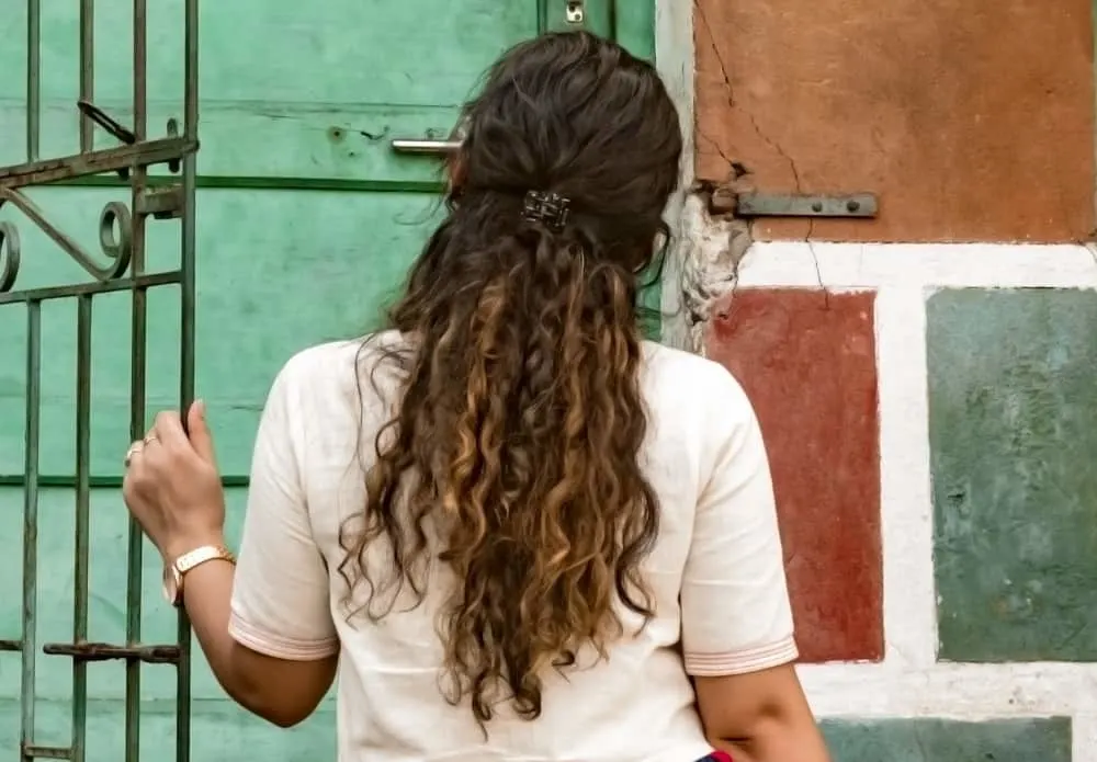 long curly half up hairstyle for over 50 women