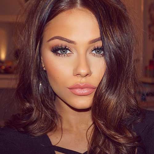 Long golden brown hair styled in soft voluminous waves.