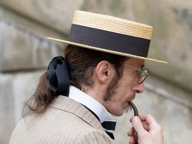 long haired man with boater hat