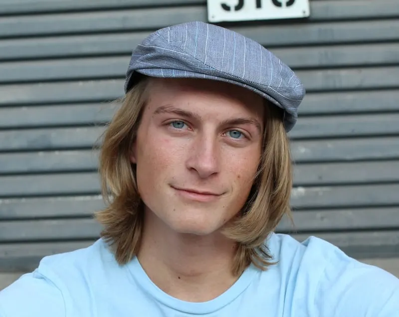 long haired man with irish hat