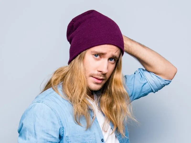 long haired man with knit caps