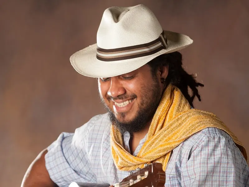 long haired man with panama hat