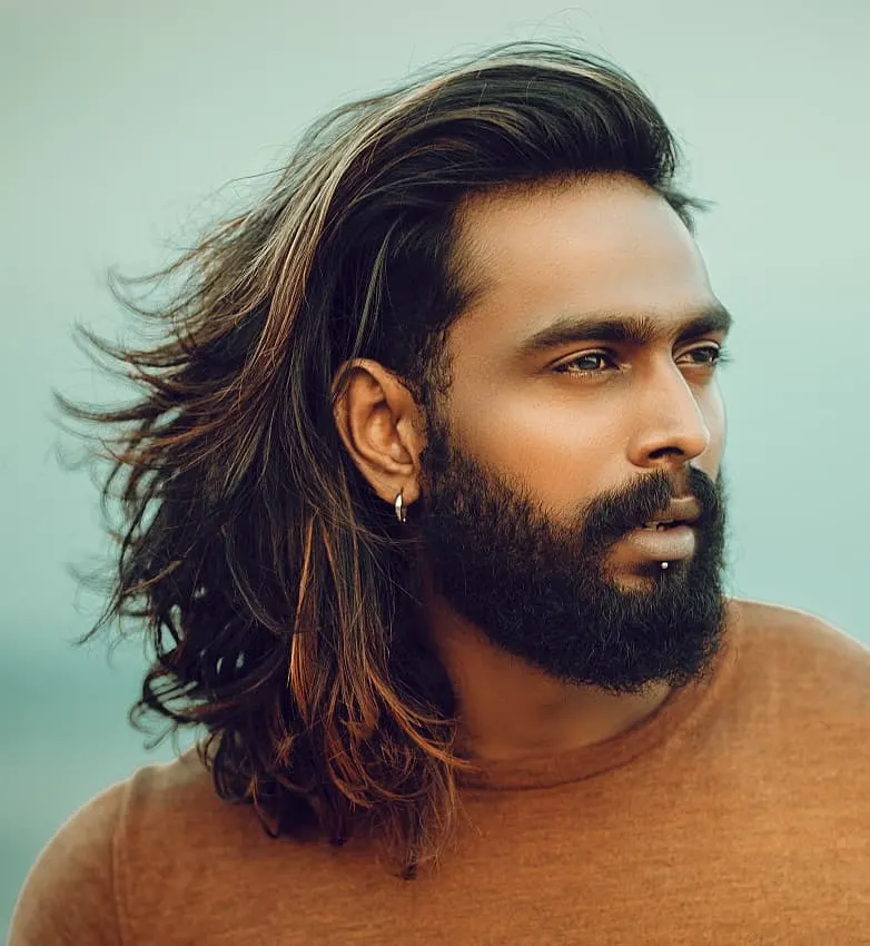 long highlighted hairstyle and full beard