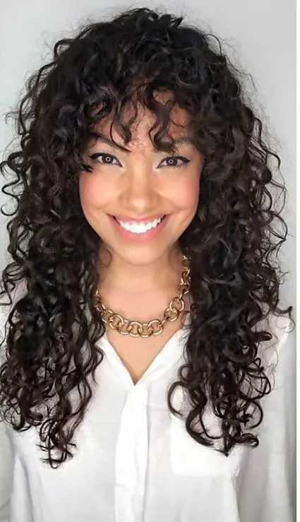 long layered curly hair with bangs