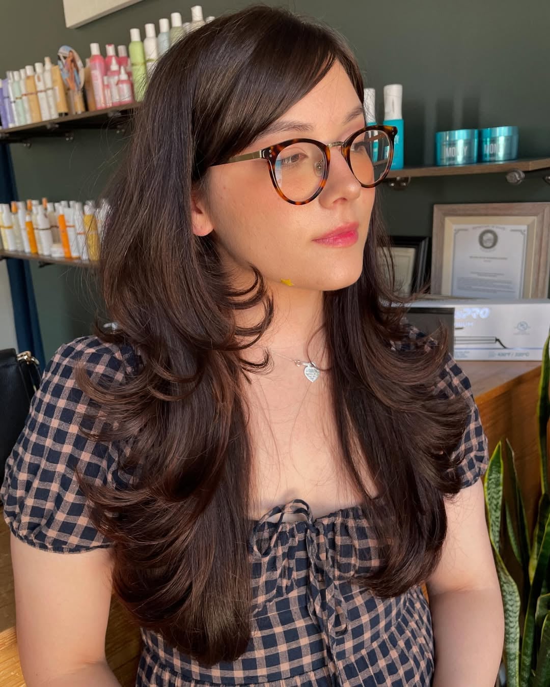 long layered dark brown hair with tucked side swept bangs