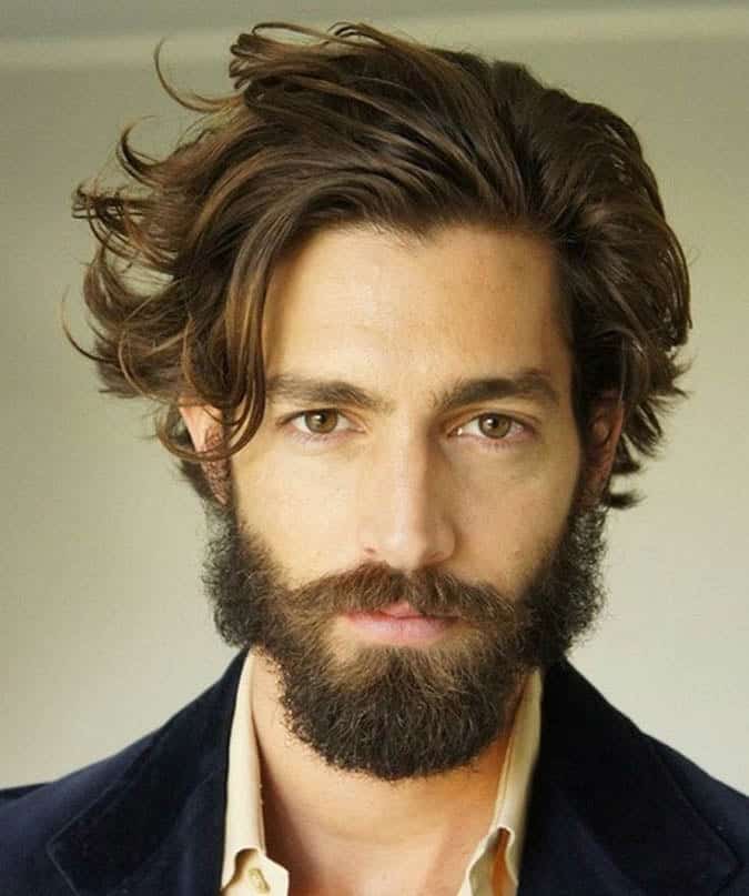 Long layered haircut with a loose side fringe softening an M-shaped receding hairline