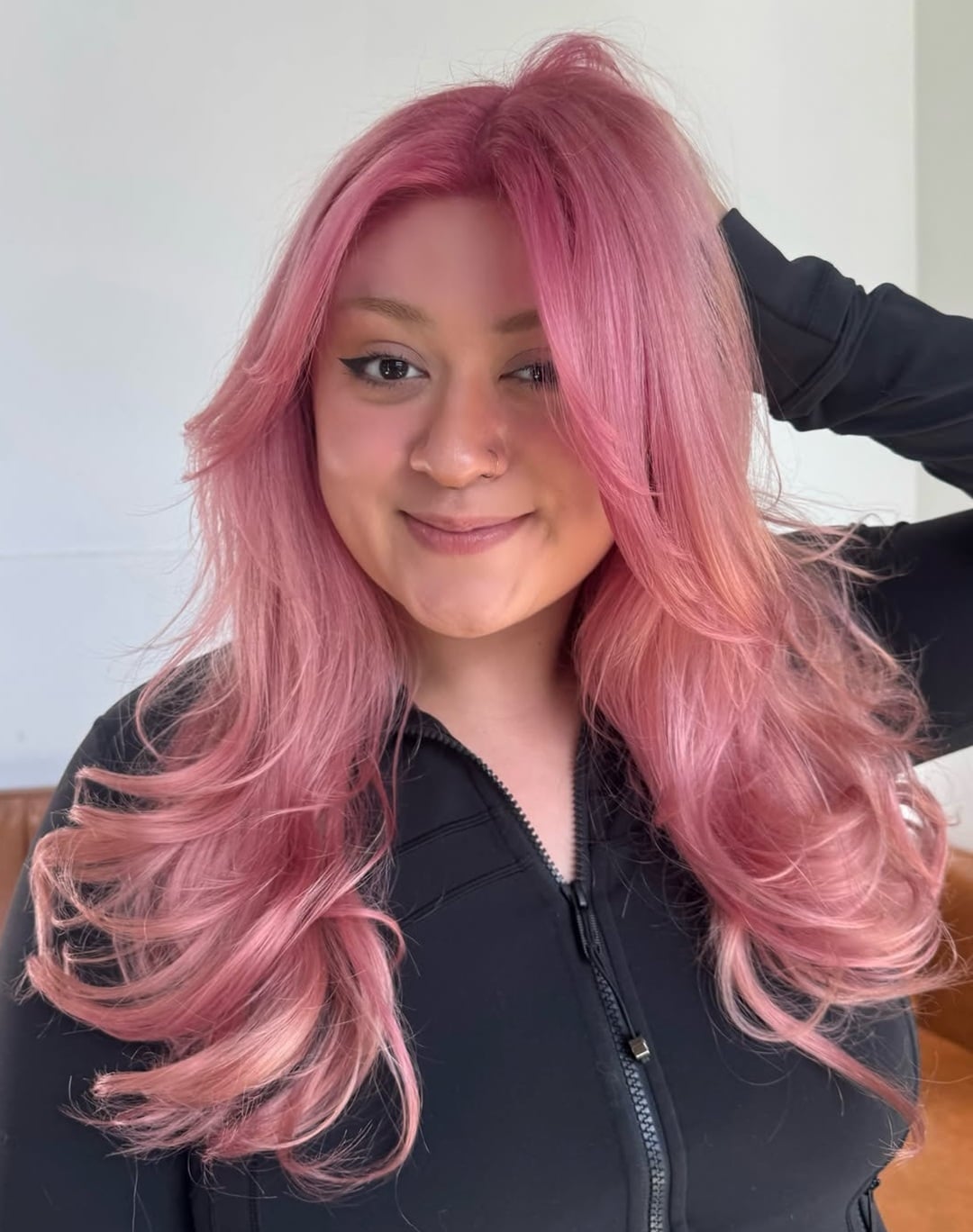 long layered pink hair with voluminous blowout and face framing curtain bangs