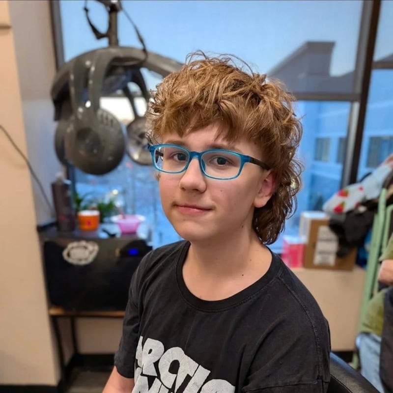 teen boy with curly, textured modern mullet