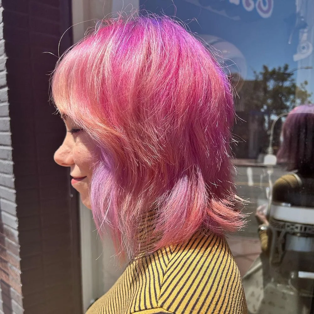 long pink bob with layers and bangs