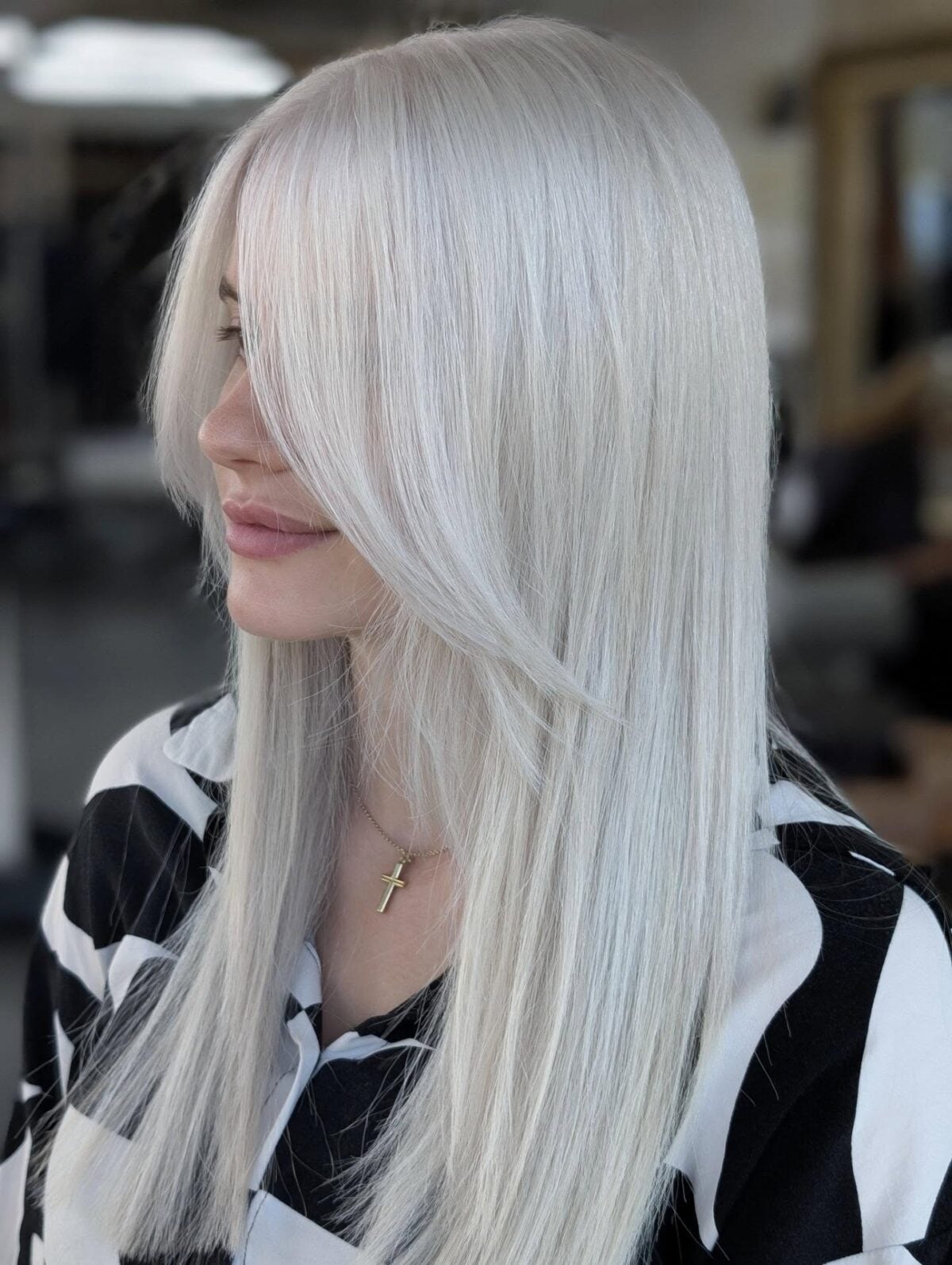 Long sleek ice blonde straight hair with face-framing layers and side bangs