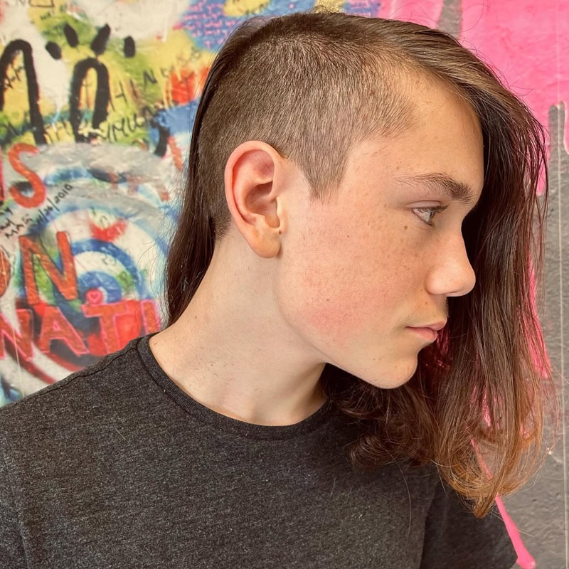 boy's undercut featuring a shaved side and long hair