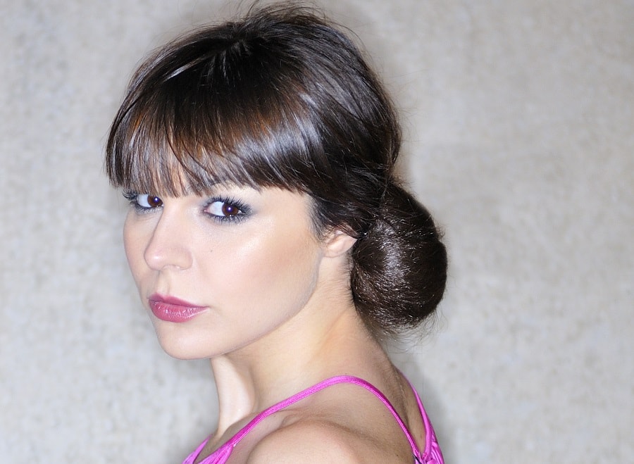 low chignon updo with blunt bangs