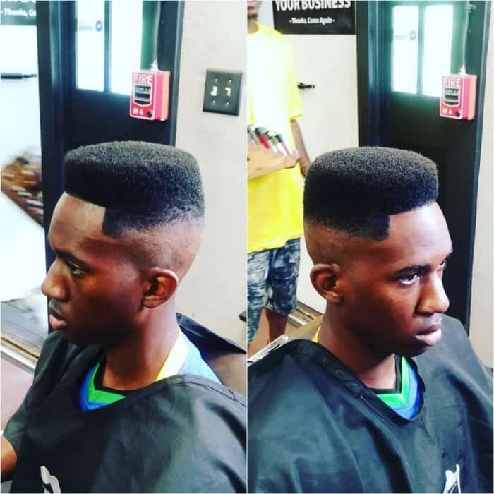 A flat, curly top with a low fade