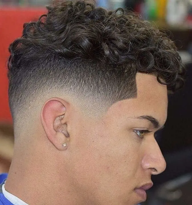 low fade hairstyle with curly top