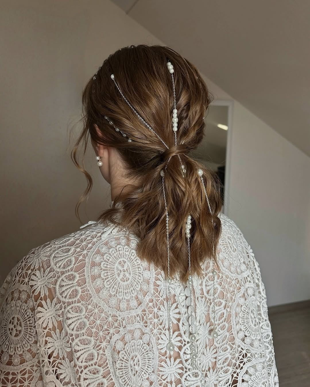 Pearl accented low ponytail formal hairstyle for women with medium hair