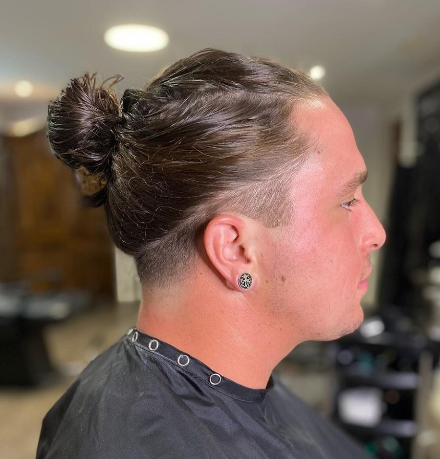 A man bun with layers and an undercut