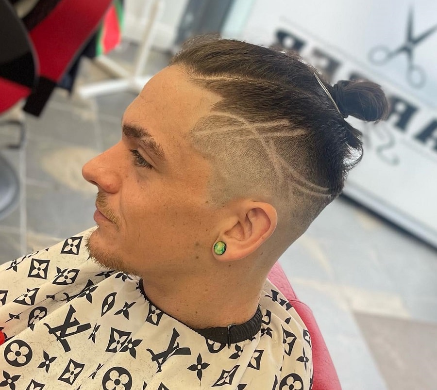 man bun with shaved sides and design