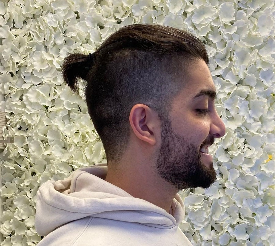 A man ponytail with layers and an undercut