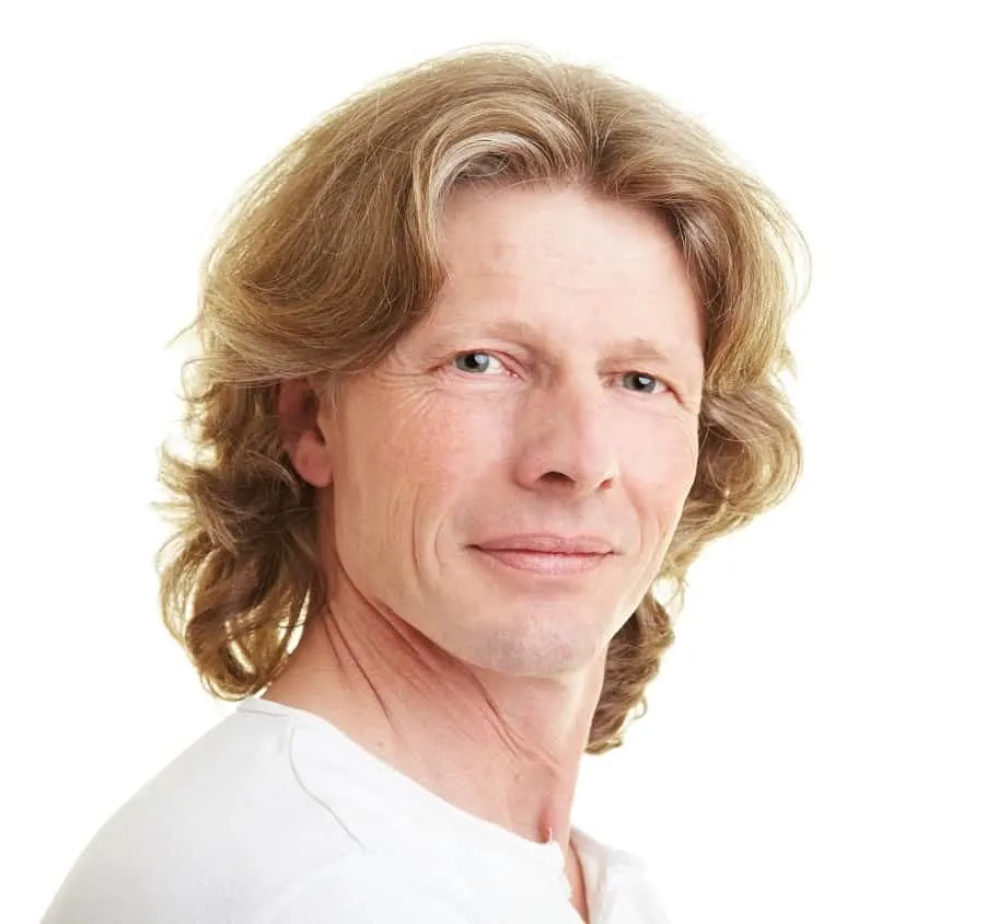 man with long blonde layered hair