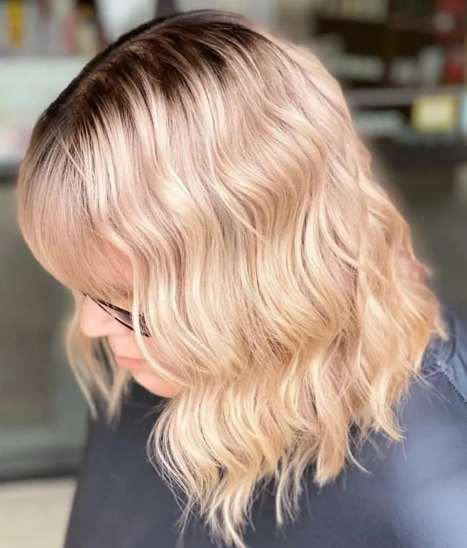 medium blonde hairstyle with shadow root