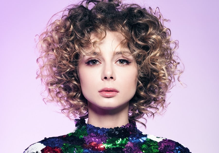 chin-length curly shag bob with defined curls and highlighted layers