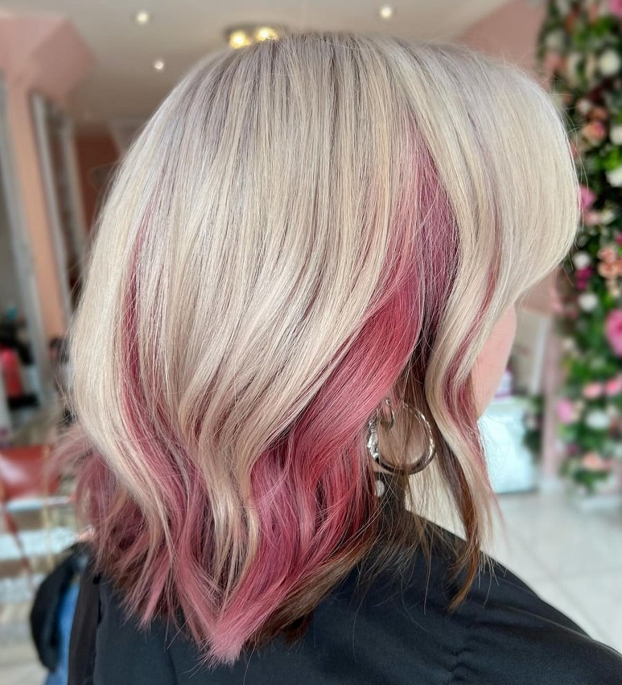 Medium length blonde hair with pink underneath