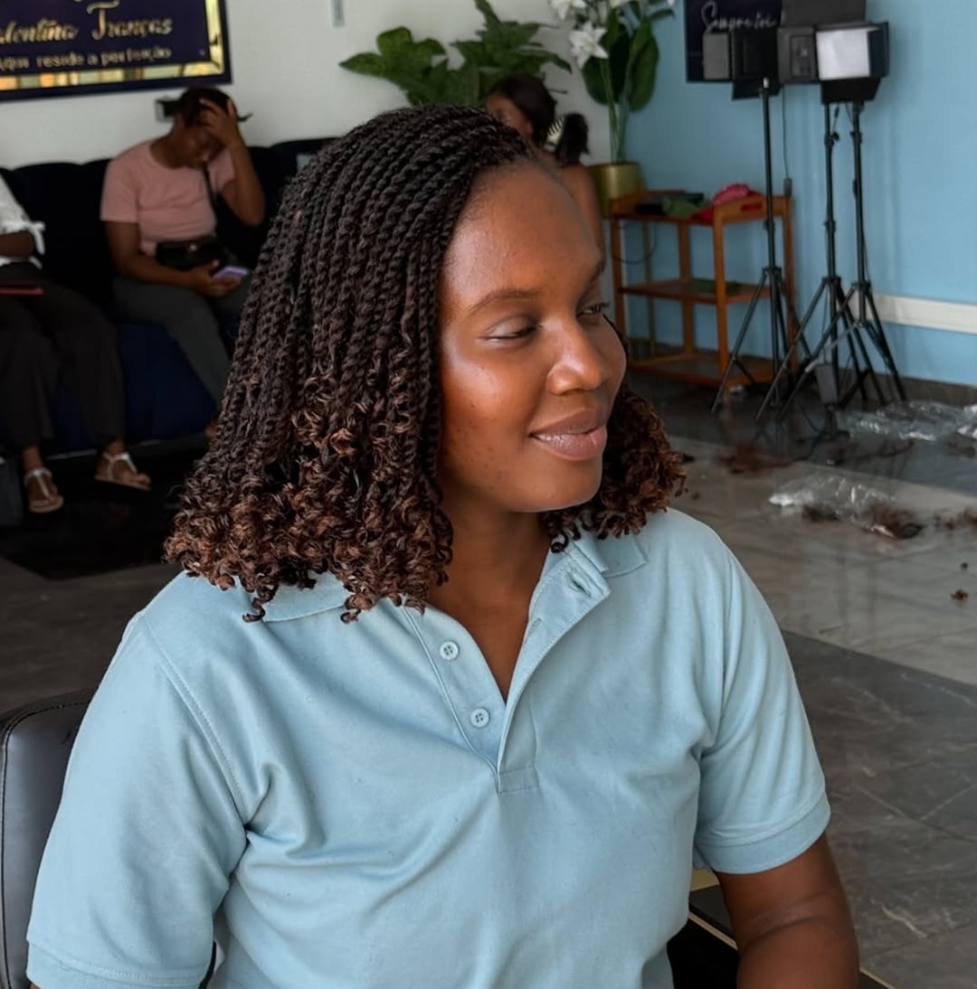 side-parted shoulder-length bob styled in medium length marley twist braids with curly ends