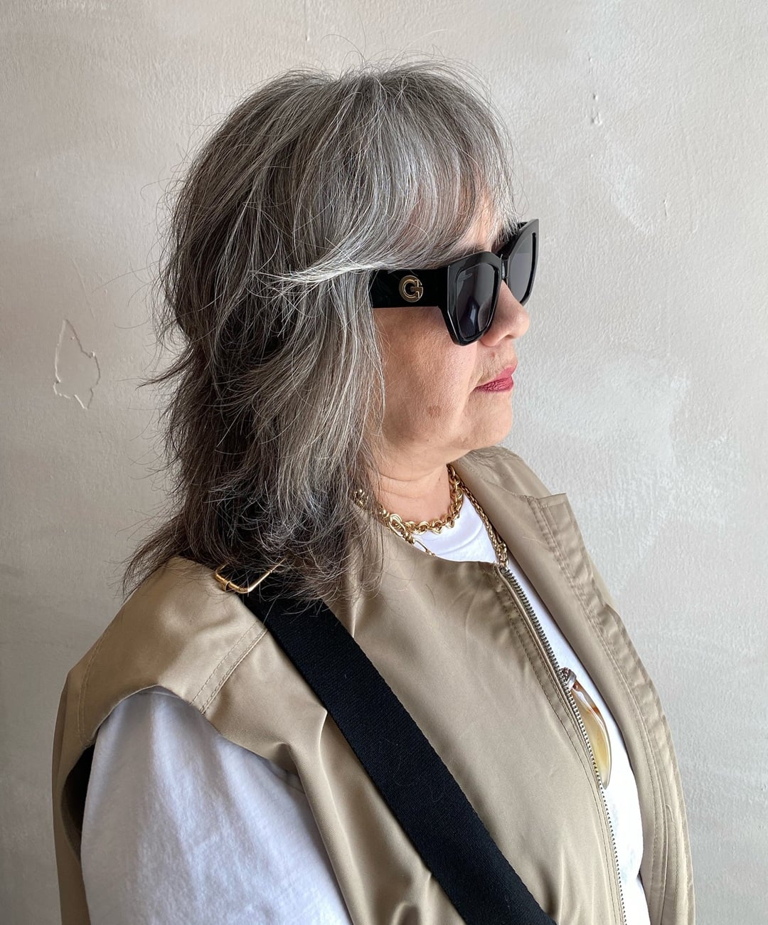 Feathered shag haircut for women over 60 with fine silver hair and layered bangs