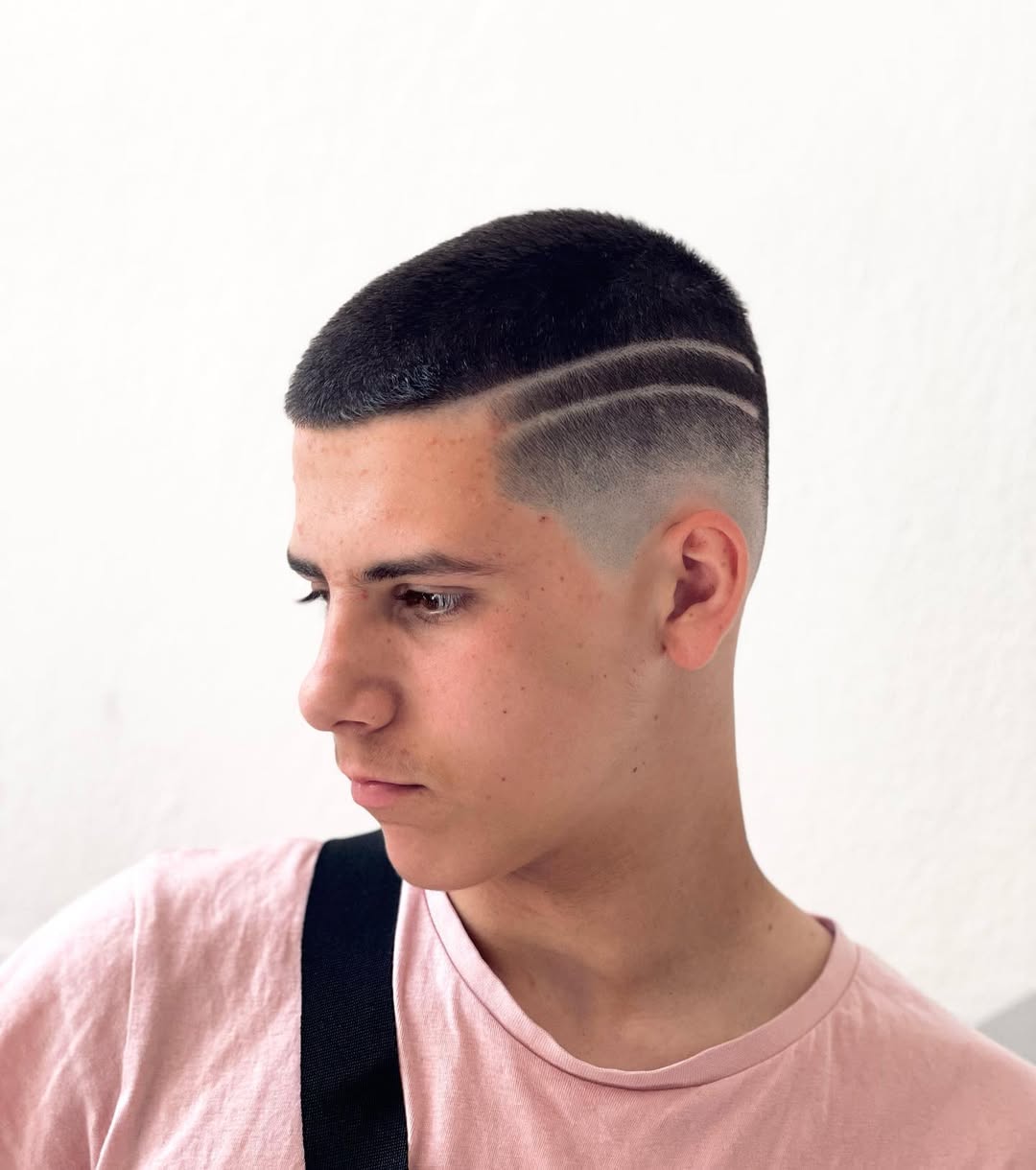 short buzz cut with high skin fade and double shaved lines