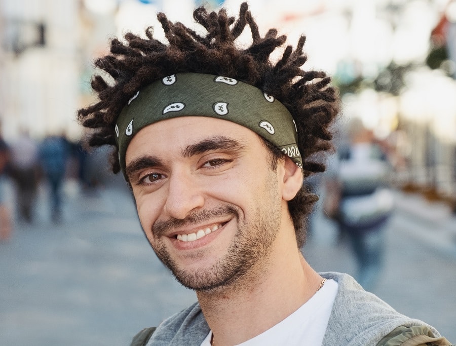 Men's hippie hairstyle with short dreads