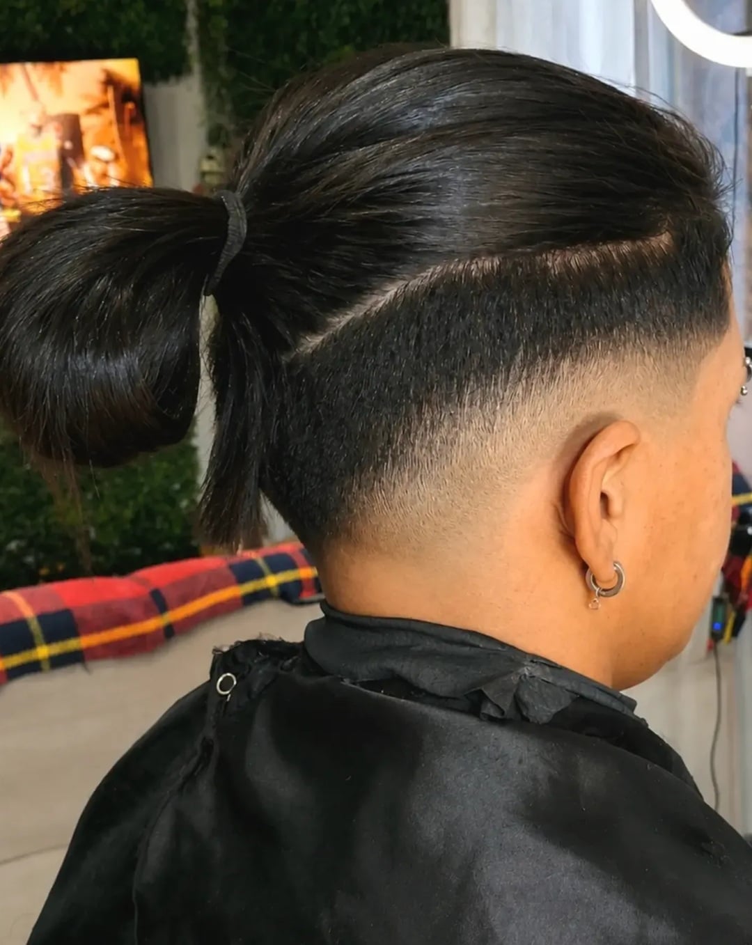 men's long ponytail hairstyle with undercut fade