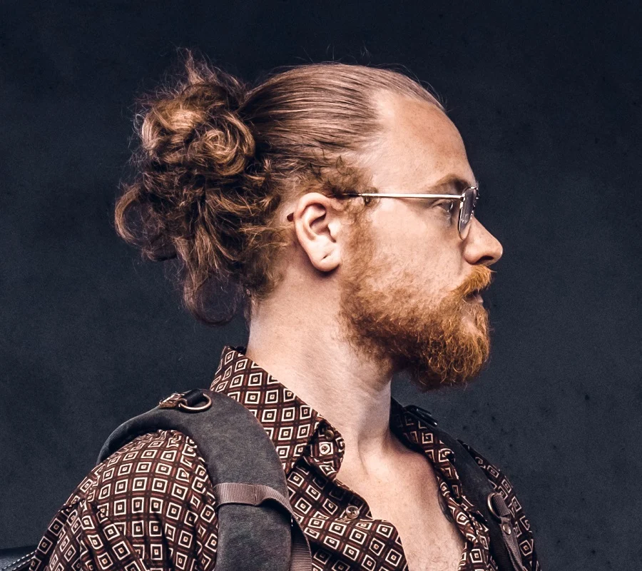 messy bun for man with glasses