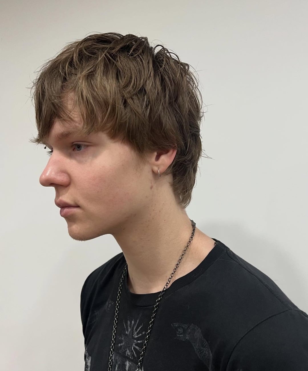 messy haircut for men with a receding hairline featuring a textured forward-swept fringe