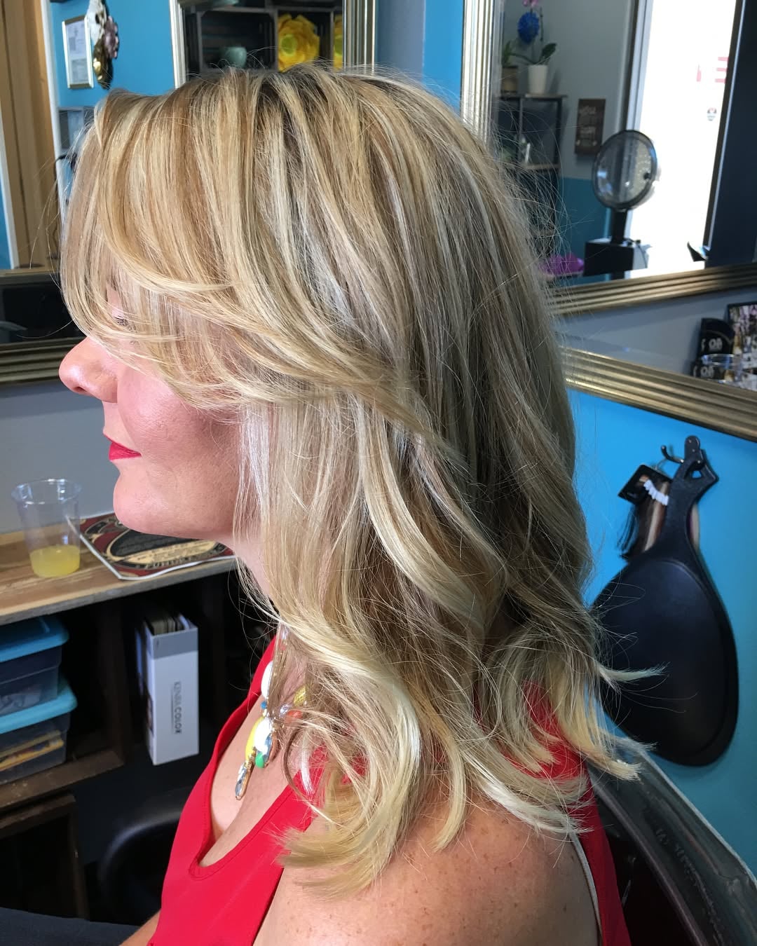 messy blonde long bob with highlights and side bangs