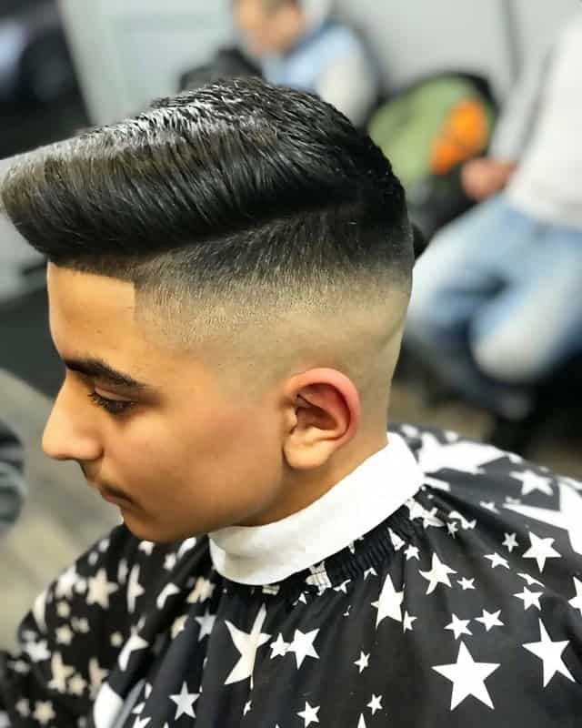 mid skin fade with pompadour