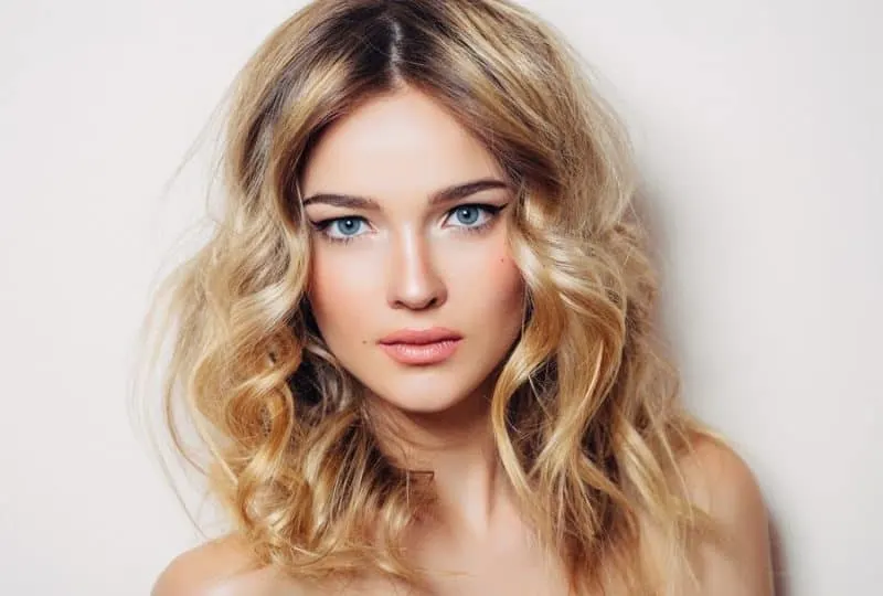 Middle part blonde hairstyle with shadow root