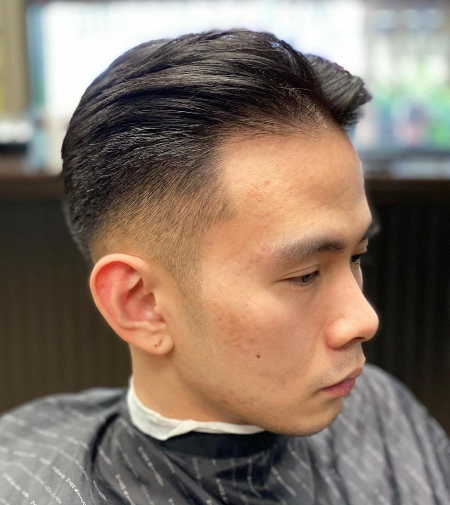Middle part fade haircut for men