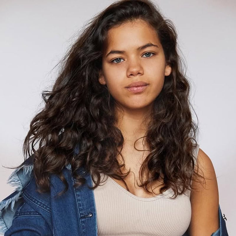 Mixed teen girl with long voluminous loose curls