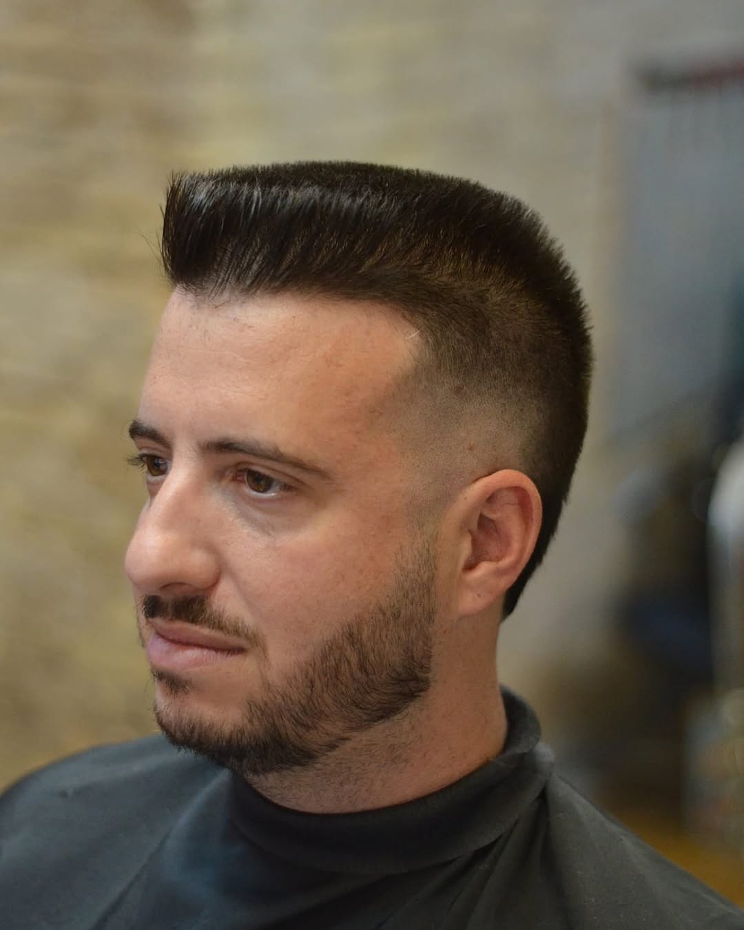 Modern flat top haircut with a mid skin fade and full beard