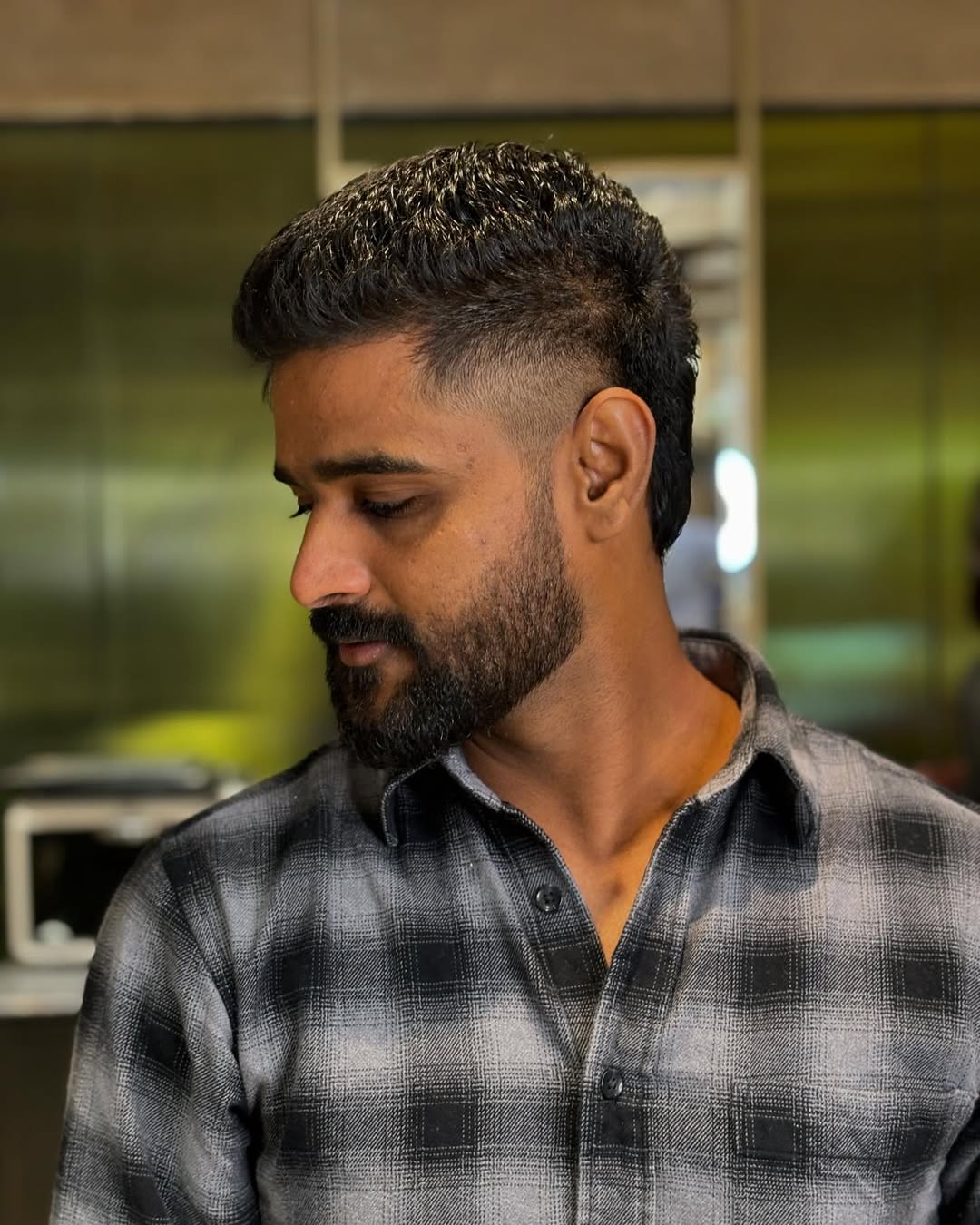 Indian Man with short textured mohawk fade