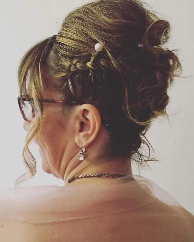 high chignon with side braid for bride's mother