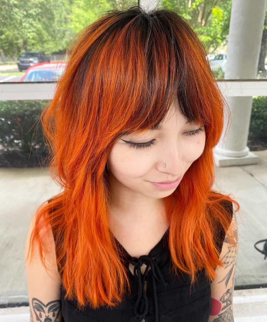 orange balayage hair with bangs