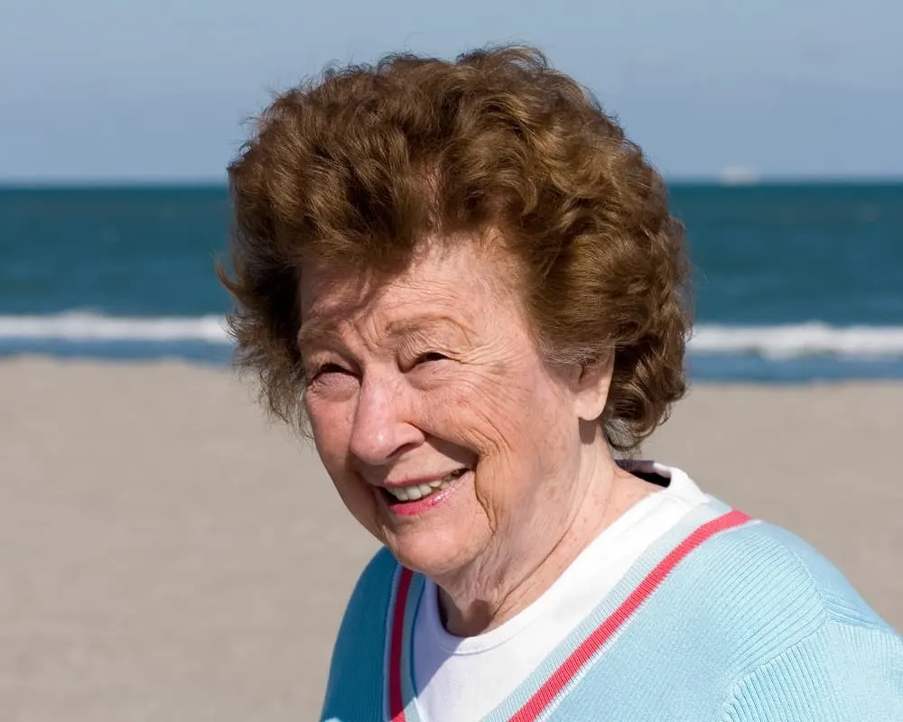 over 60 woman with short brown curls