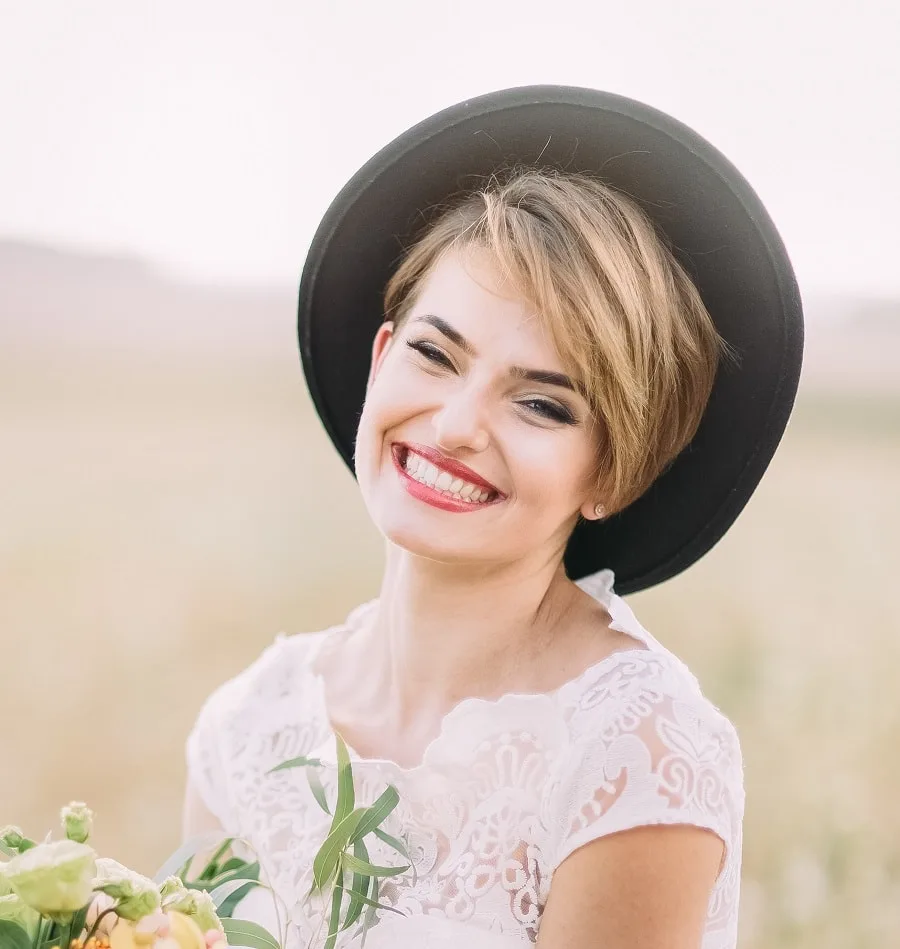 Pixie haircut with a hat for a wedding