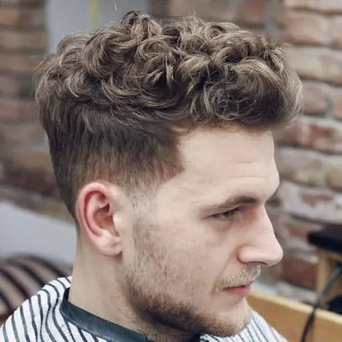curly pompadour hairstyle with undercut