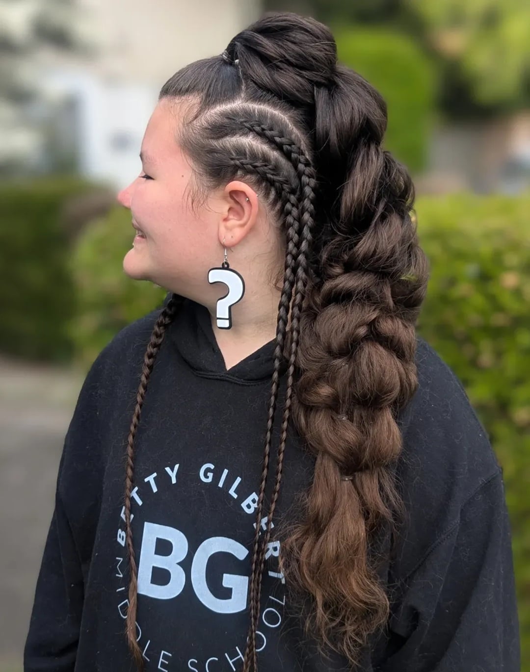 Long dark brown voluminous pull-through warrior braid hairstyles for women featuring side cornrows