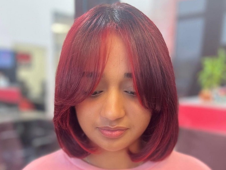 Red bob with curtain bangs